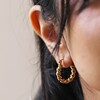 Close Up of Model Wearing Medium Twisted Rope Hoop Earrings in Gold