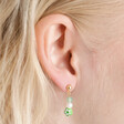Close Up of Millefiori Green Flower Drop Earrings in Gold on Model