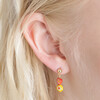 Close up of Millefiori Heart and Flower Drop Earrings in Gold on model