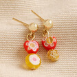 Millefiori Heart and Flower Drop Earrings in Gold on beige coloured fabric