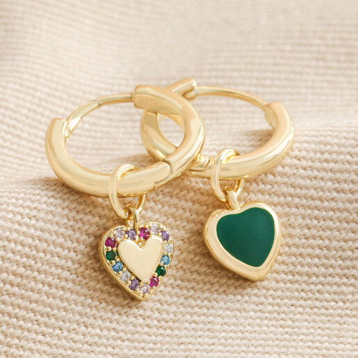Mismatched Crystal Enamel Heart Huggie Hoops in Gold on beige coloured material