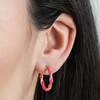 Close Up of Pink Twisted Enamel Hoop Earrings in Gold on Model