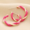 Pink Twisted Enamel Hoop Earrings in Gold on Neutral Coloured Fabric