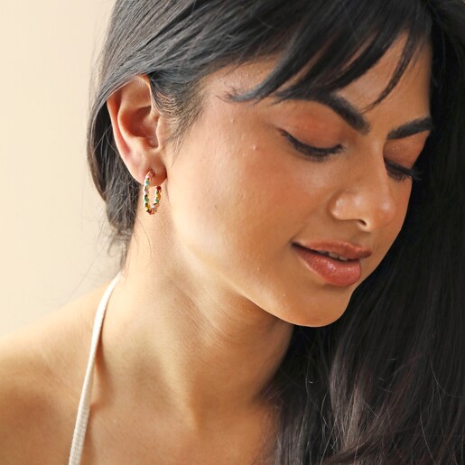 Earrings on Model Model Wears Rainbow Enamel Twist Hoop Earrings in Gold