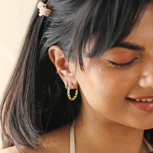 Close Up of Earrings on Model Close Up of Rainbow Enamel Twist Hoop Earrings in Gold on Model