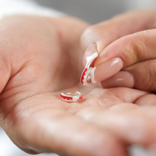 Model Holding Red Enamel Scalloped Huggie Hoop Earrings in Silver