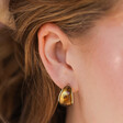 Model Wearing Small Amber Resin Hoop Earrings in Gold