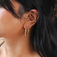 Model Wearing Large Twisted Rope Hoop Earrings in Gold With Medium Size