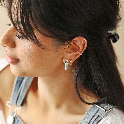 Model Looking to Side Wearing White Cloisonné Hoop Earrings in Gold