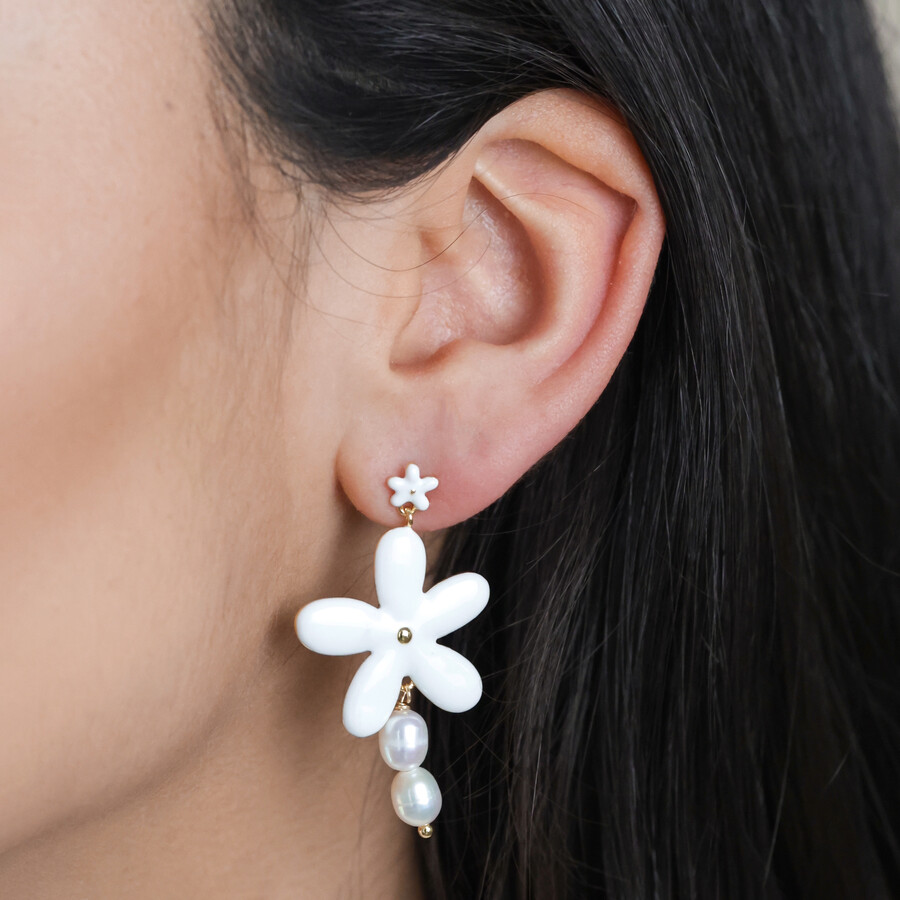 White Enamel and Pearl Daisy Drop Earrings in Gold on model with dark hair
