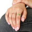 Green and Pink Enamel Adjustable Rings in Gold on Models Hand on Knee with White Background
