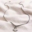 Full Length of Men's Personalised Stainless Steel Anchor Pendant Necklace on Beige Fabric