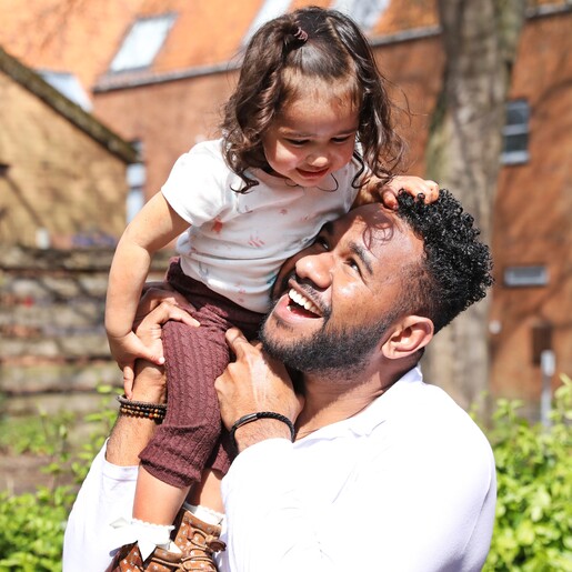 Dad holding daughter wearing Men's Tiger's Eye Bead Bracelet 