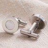 Mother of Pearl Round Cufflinks in Silver with One Facing Other Way on Beige Fabric