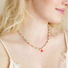 Model looking to side wearing Colourful Pearl and Tassel Beaded Necklace in Gold 