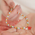 Model Holding Colourful Pearl and Tassel Beaded Necklace in Gold in Palm of Hand
