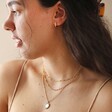 Model Wearing Personalised Birth Flower Crystal Edge Pendant Necklace in Gold with Other Necklaces