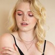 Model looking down wearing Freshwater Pearl Chain Necklace in Gold in curated look
