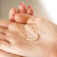Model holding Freshwater Pearl Chain Necklace in Gold in palm of hand