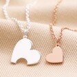 Mother & Child Set of 2 Heart Puzzle Necklaces in Silver and Rose Gold on Beige Fabric