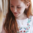 Young Red-Headed Model Wearing Sun Necklace from the Mother & Child Set of 2 Sun and Moon Necklaces in Gold