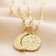 Mother & Child Set of 2 Sun and Moon Necklaces in Gold Linked Together on Beige Fabric