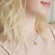 Model wearing Dove Charm Pearl Beaded Necklace in Gold