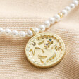 Close up of pendant on Dove Charm Pearl Beaded Necklace in Gold