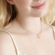 Model smiling wearing Personalised Birth Flower Crystal Edge Pendant Necklace in Gold