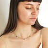 Model looking down wearing Semi-Precious Jade Stone Droplet Necklace in Gold