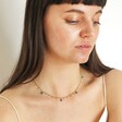 Model looking down wearing Semi-Precious Jade Stone Droplet Necklace in Gold
