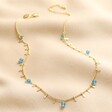 Semi-Precious Jade Stone Droplet Necklace in Gold on neutral coloured fabric