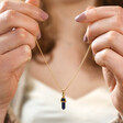 Model Holding Sodalite Crystal Point Pendant Necklace in Gold