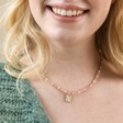Close Up of Model Smiling Wearing Talisman Moon Charm Pink and Pearl Beaded Necklace in Gold