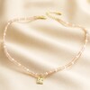 Talisman Moon Charm Pink and Pearl Beaded Necklace in Gold on Neutral Coloured Fabric