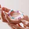 Model Holding Positive Energy Semi-Precious Stone Beaded Bracelet in Pink