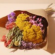 Bright Market Style Dried Flower Bouquet Wrapped in Paper on Neutral Background