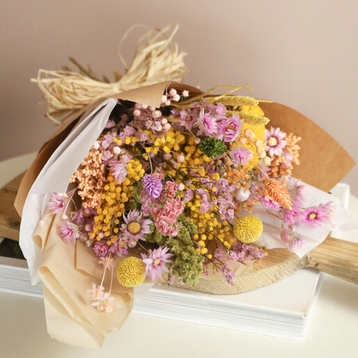 Spring Meadow Dried Flower Bouquet in Wrapping on Beige Background