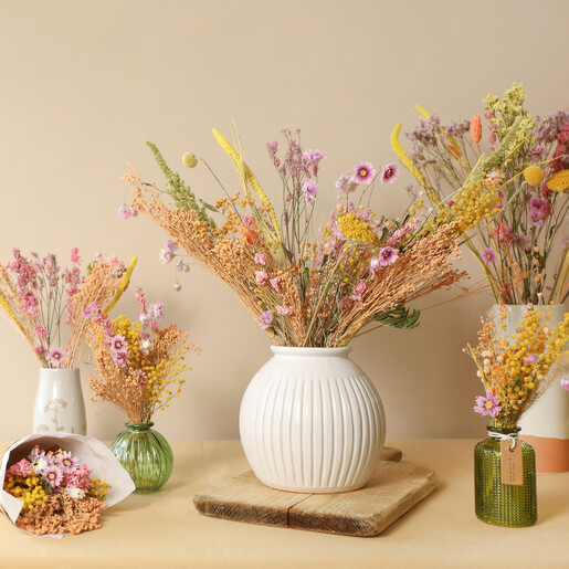 Spring Meadow Dried Flower Posy in Vase Next to Other Arrangements with Beige Background