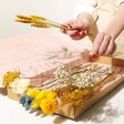 Model Holding Stems From Large Yellow and Blue Dried Flowers Letterbox Gift