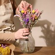 Model Arranging Bright Market Style Dried Flower Bouquet in Clear Vase