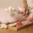 Model Arranging Stems from Long Stem Vintage Pink Dried Flower Letterbox Bouquet in Packaging