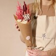 Model Holding Love You Lots Valentine's Small Dried Flower Bouquet Wrapped in Brown Kraft Paper