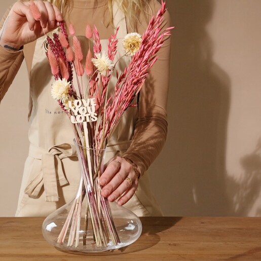 Model Arranging Love You Lots Valentine's Small Dried Flower Bouquet in Glass Vase
