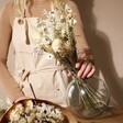 Model Holding Natural Market Style Dried Flower Bouquet in Vase with Natural Market Style Dried Flower Bouquet in Paper