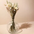 Natural Market Style Dried Flower Bouquet in Glass Vase with Beige Background