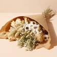 Natural Market Style Dried Flower Bouquet in Paper on Beige Background
