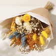 Yellow and Blue Dried Flower Bouquet Wrapped in Brown Paper