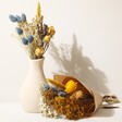 Yellow and Blue Dried Flower Posy Arranged in Vase Alongside Wrapped Posy