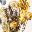 Close Up of Yellow Roses in Yellow and Blue Dried Flower Posy